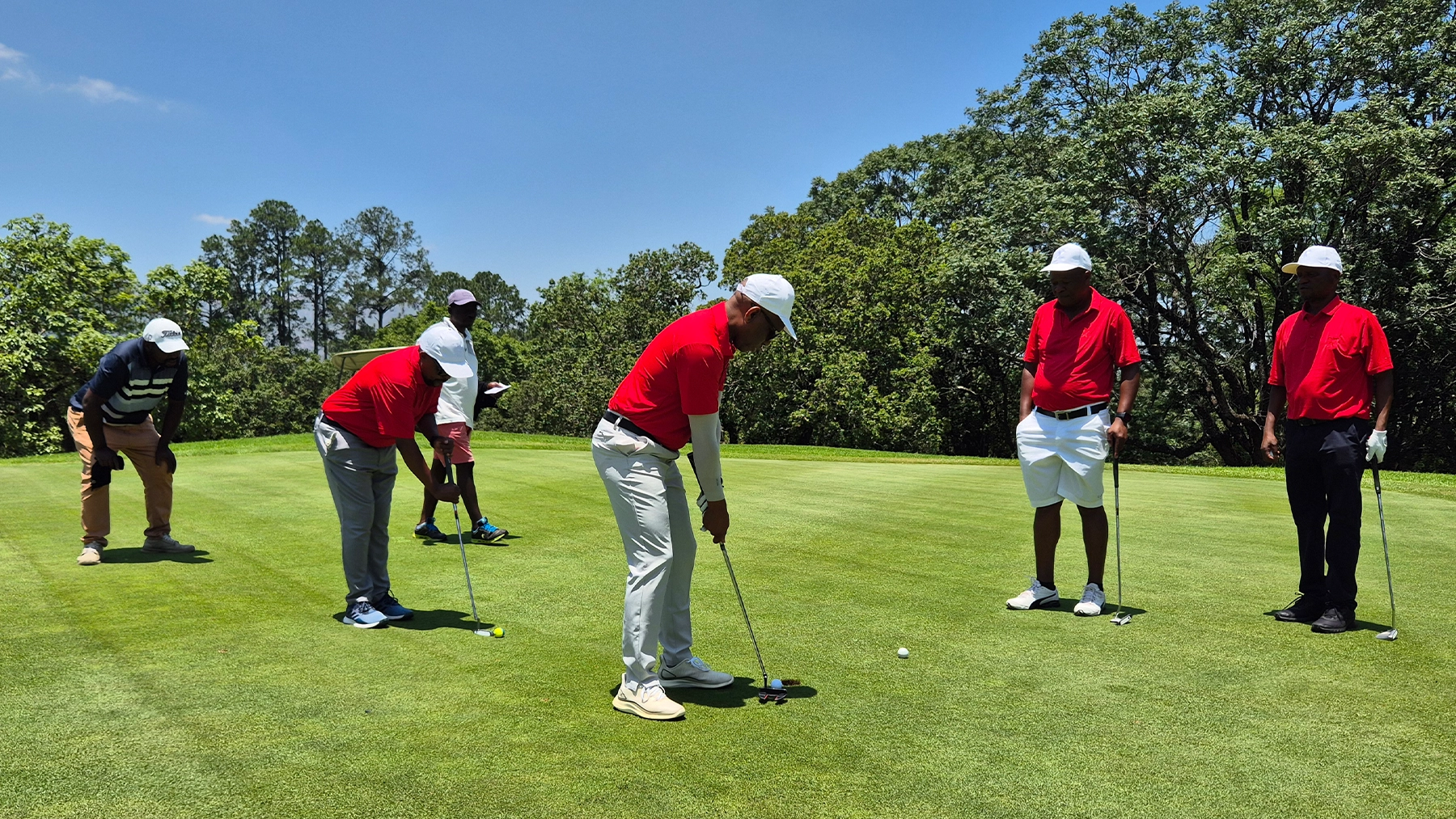 ESR Golf Day 2024 — Players putting on the green