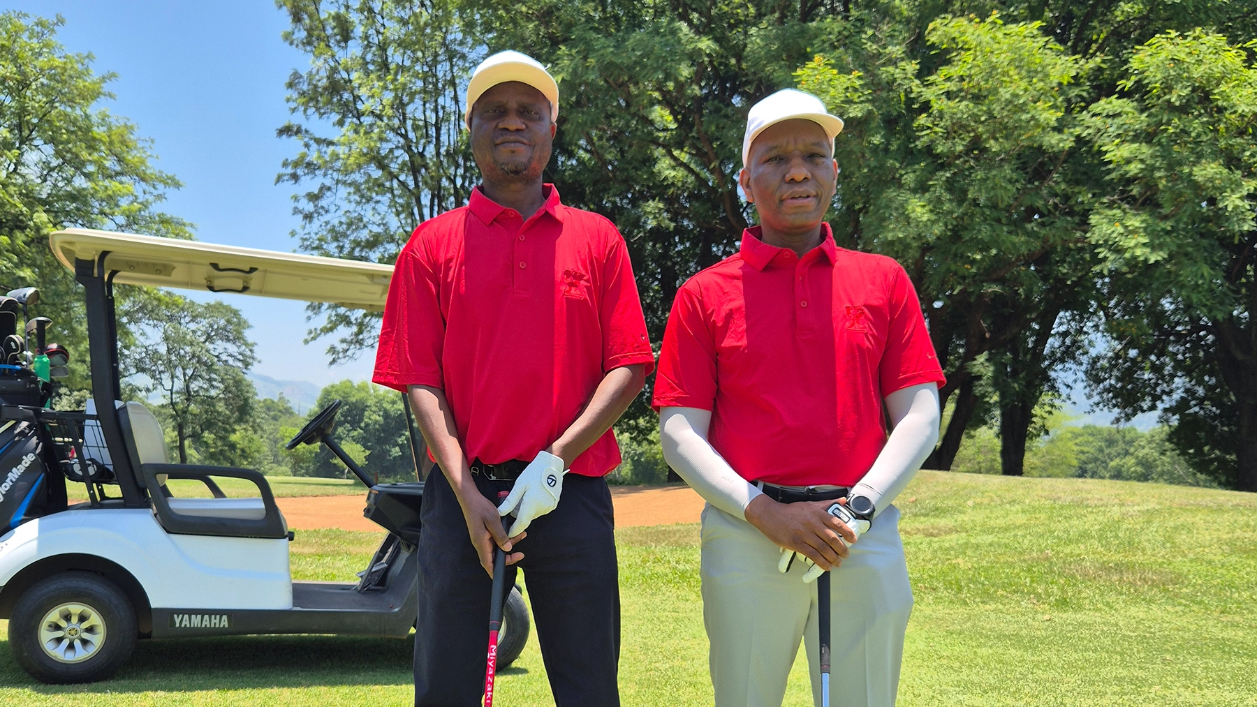 ESR Golf Day 2024 — Golfers beside their cart